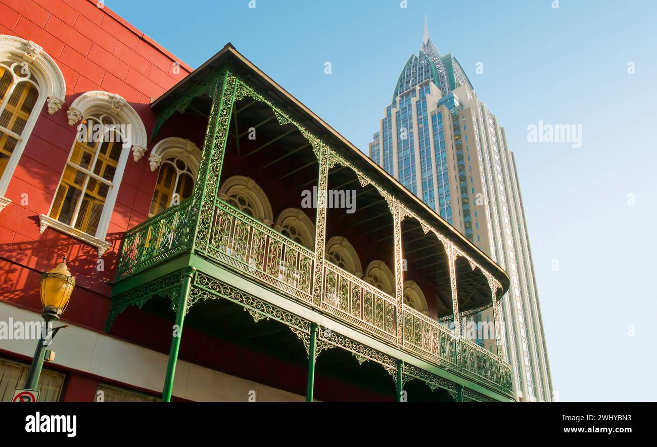 grill work on building in Lower Dauphin Street Historic District, and RSA Battle House Tower in downtown Mobile, Alabama - USA Stock Photo