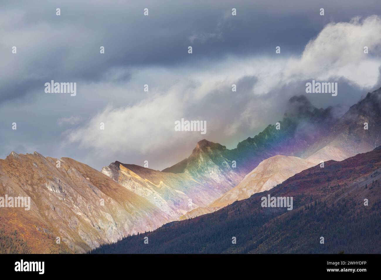 Rainbow in mountains Stock Photo