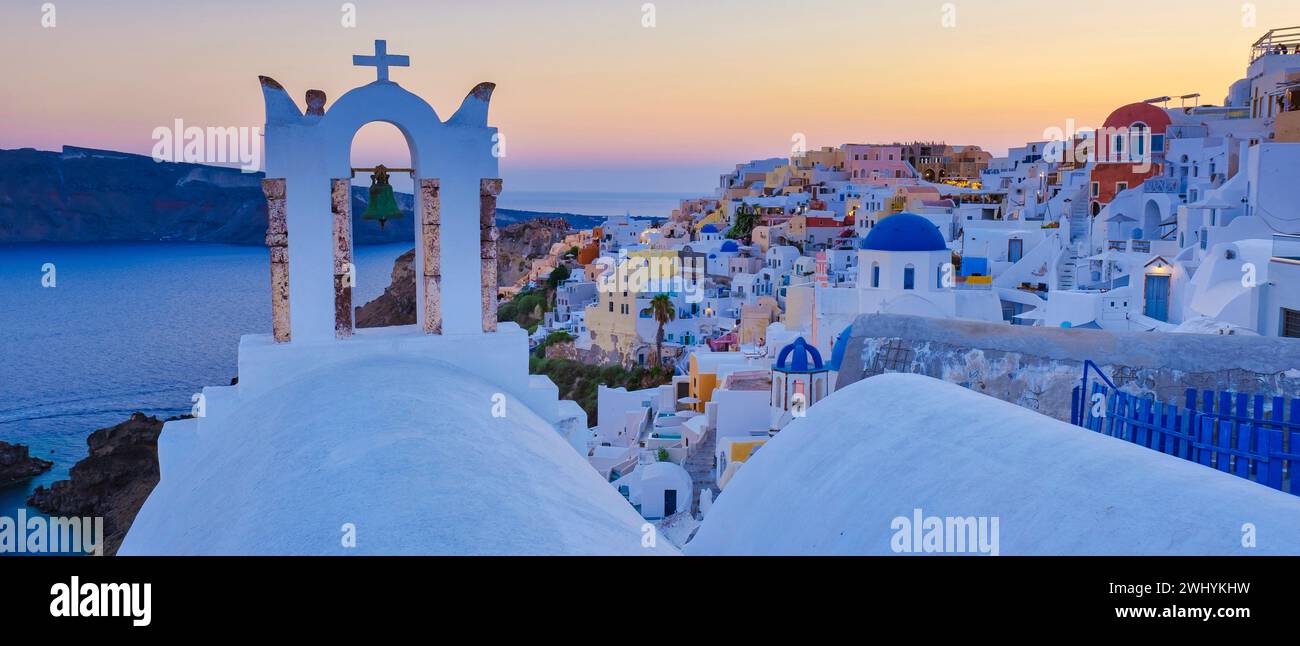 White churches an blue domes by the ocean of Oia Santorini Greece, traditional Greek village Stock Photo