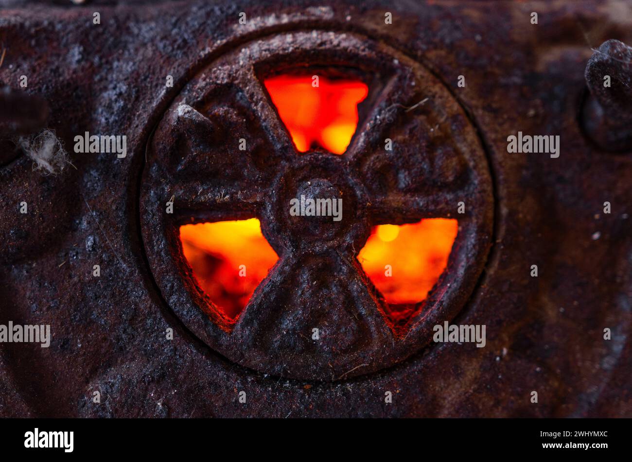 Radioactive symbol, Cast iron, Backlit, Glowing coals, Flame, Warning sign, Danger, Nuclear hazard, Radiation symbol Stock Photo