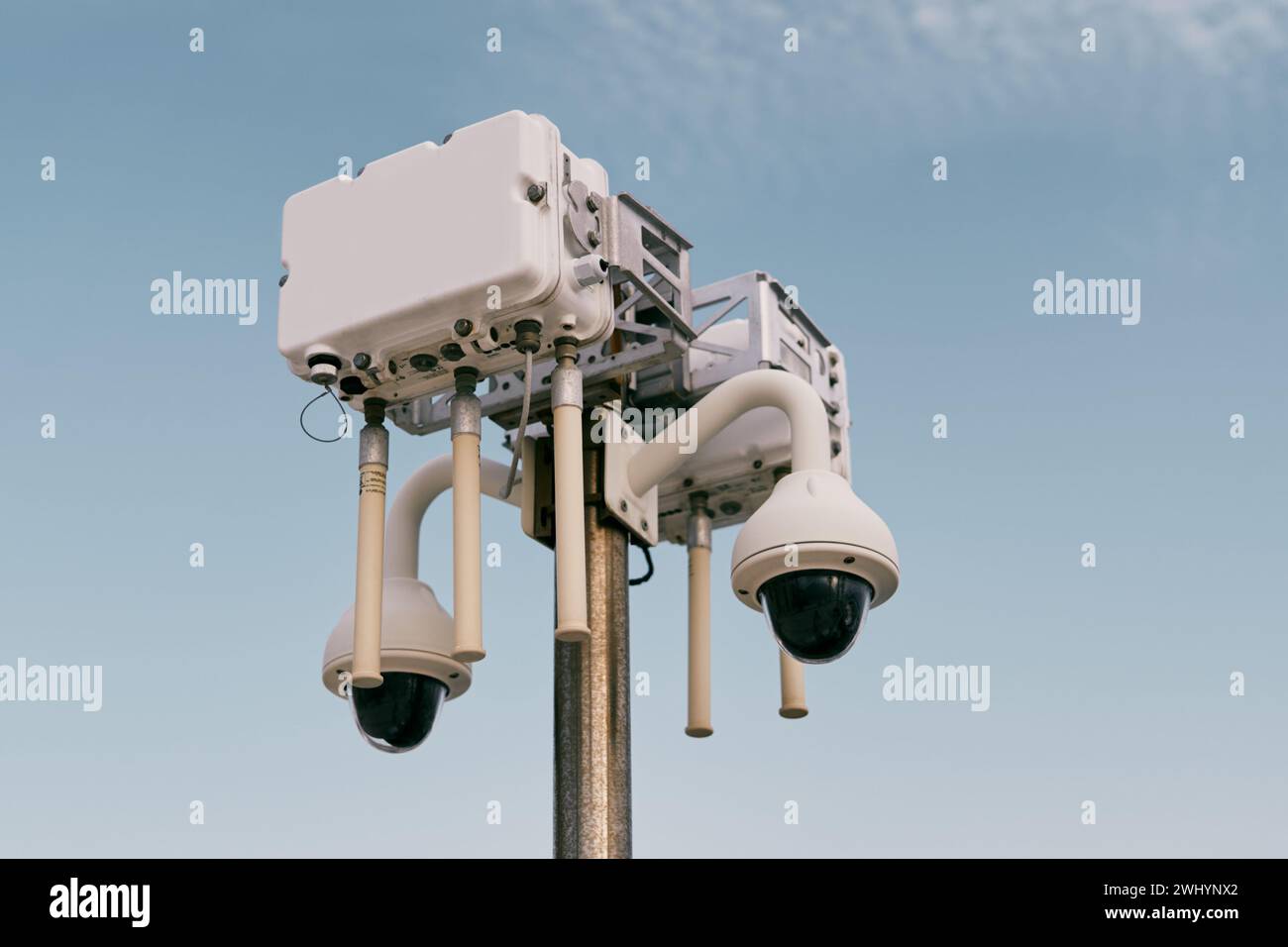 Street wi-fi router on a pole with video cameras against the sky Stock Photo