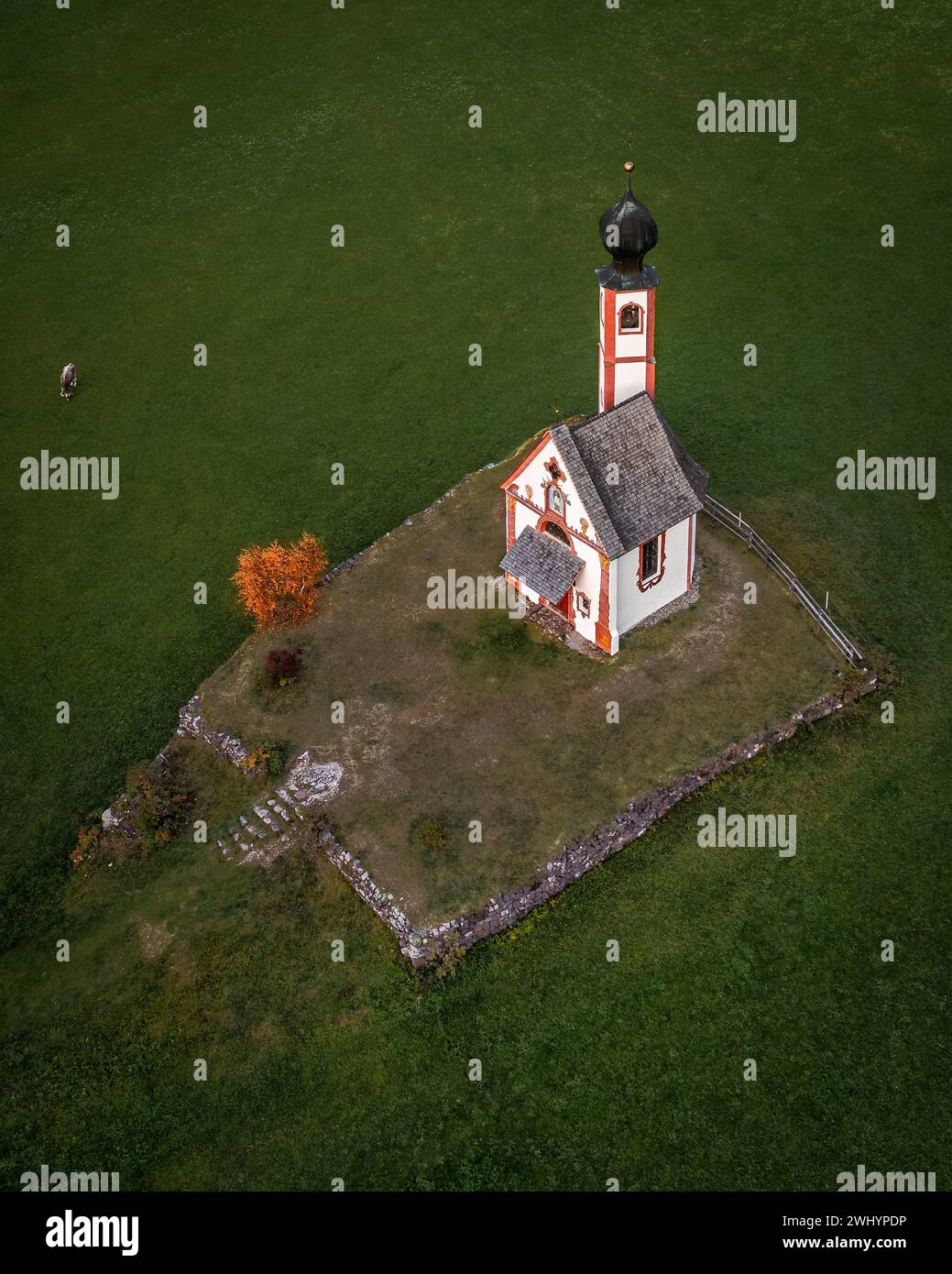 Val Di Funes, Dolomites, Italy - Aerial view of the beautiful St. Johann Church (Chiesetta di San Giovanni in Ranui) at South Tyrol with green grass, Stock Photo