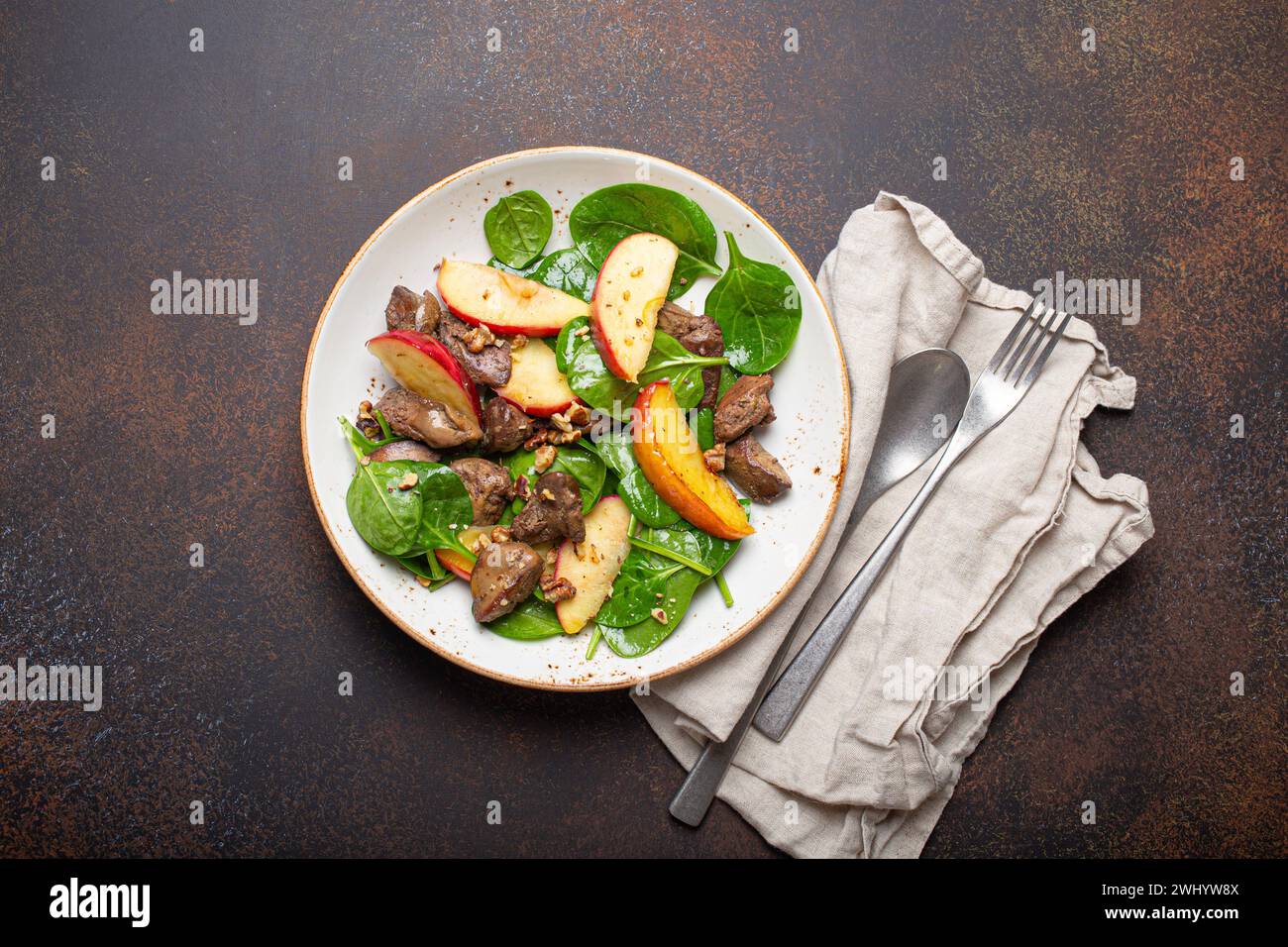 Healthy Salad with Iron Rich Ingredients Chicken Liver, Apples, Fresh Spinach and Walnuts on