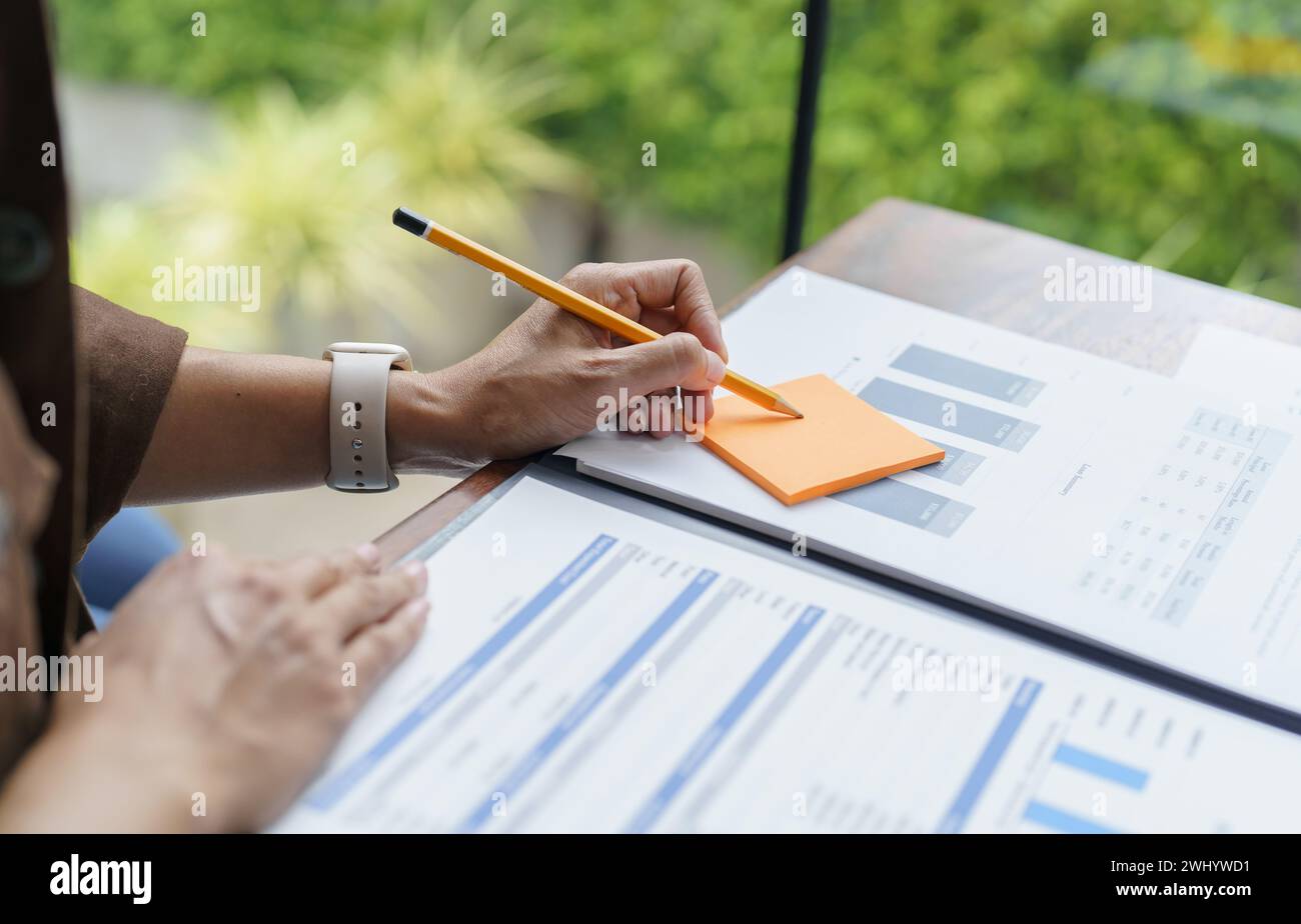 Business People working on sticky notes creative writing down ideas on post it notes professional investor start up project busi Stock Photo