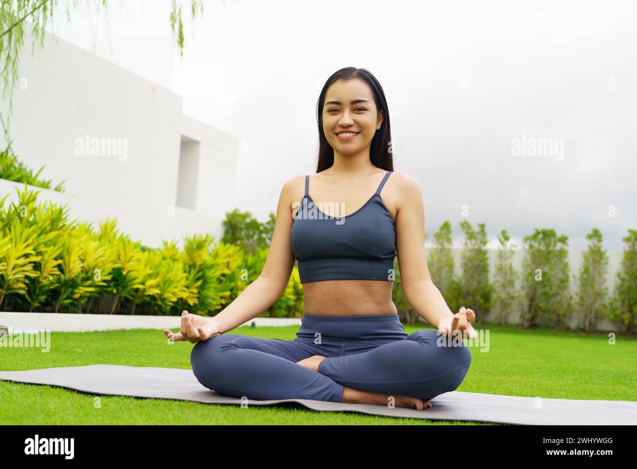 BeautifulÂ confident asian woman practices yoga Â in green park relax in nature. Portrait Asian girl do serene sincere peacefulÂ Stock Photo