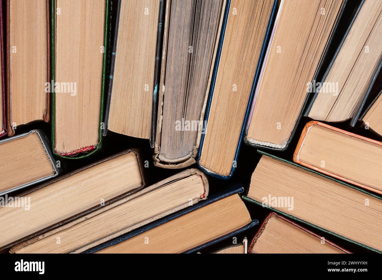 Many different hardcover old books on dark background, top view Stock Photo