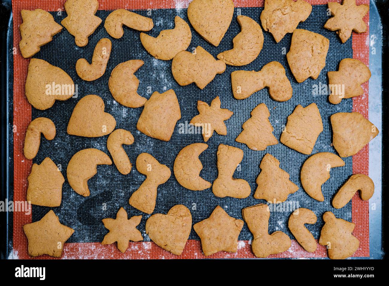 Freshly baked Christmas cookies lie on a baking sheet. Top view Stock Photo
