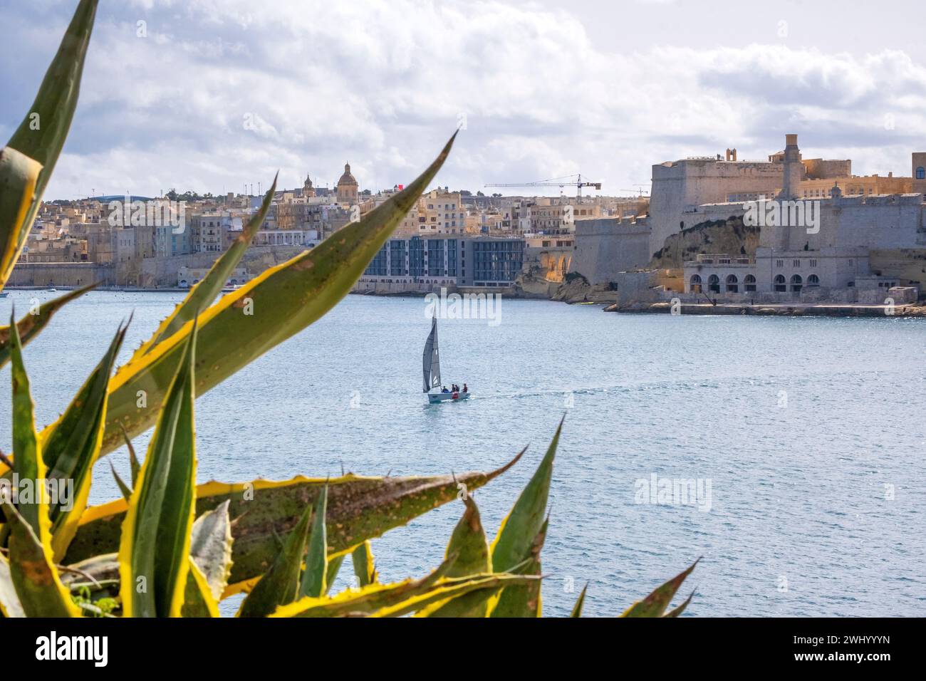 A sailboat crosses the harbor of Valletta, Malta, from Fort St. Elmo in Birgu Stock Photo