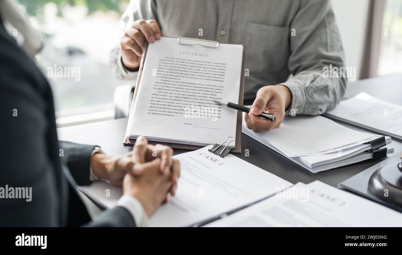 Lawyer Legal counsel presents to the client a signed contract with gavel and legal law. justice and lawyer Business partnership Stock Photo