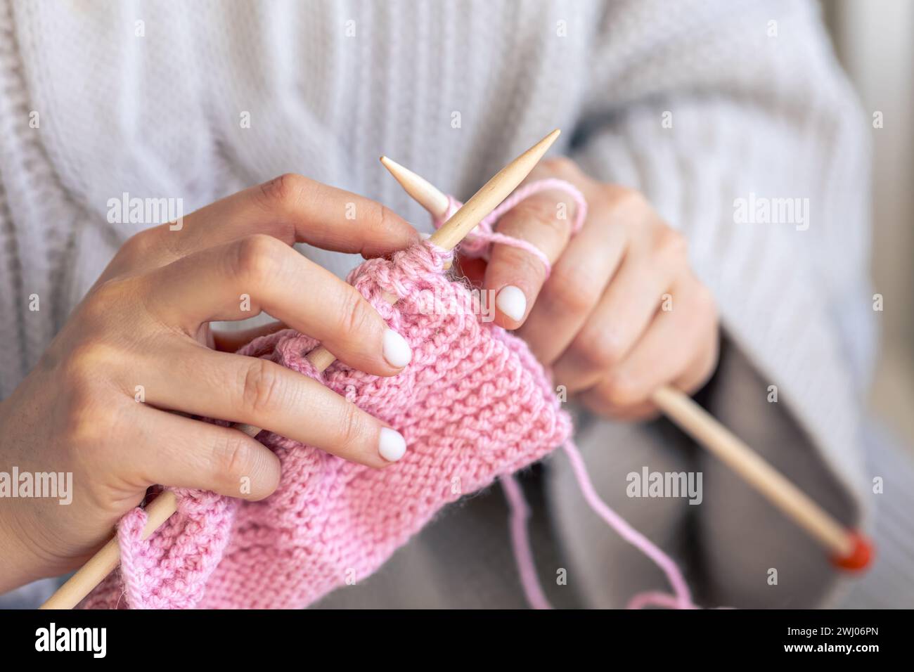 Close-up of hands knitting using circular needles. Stock Photo