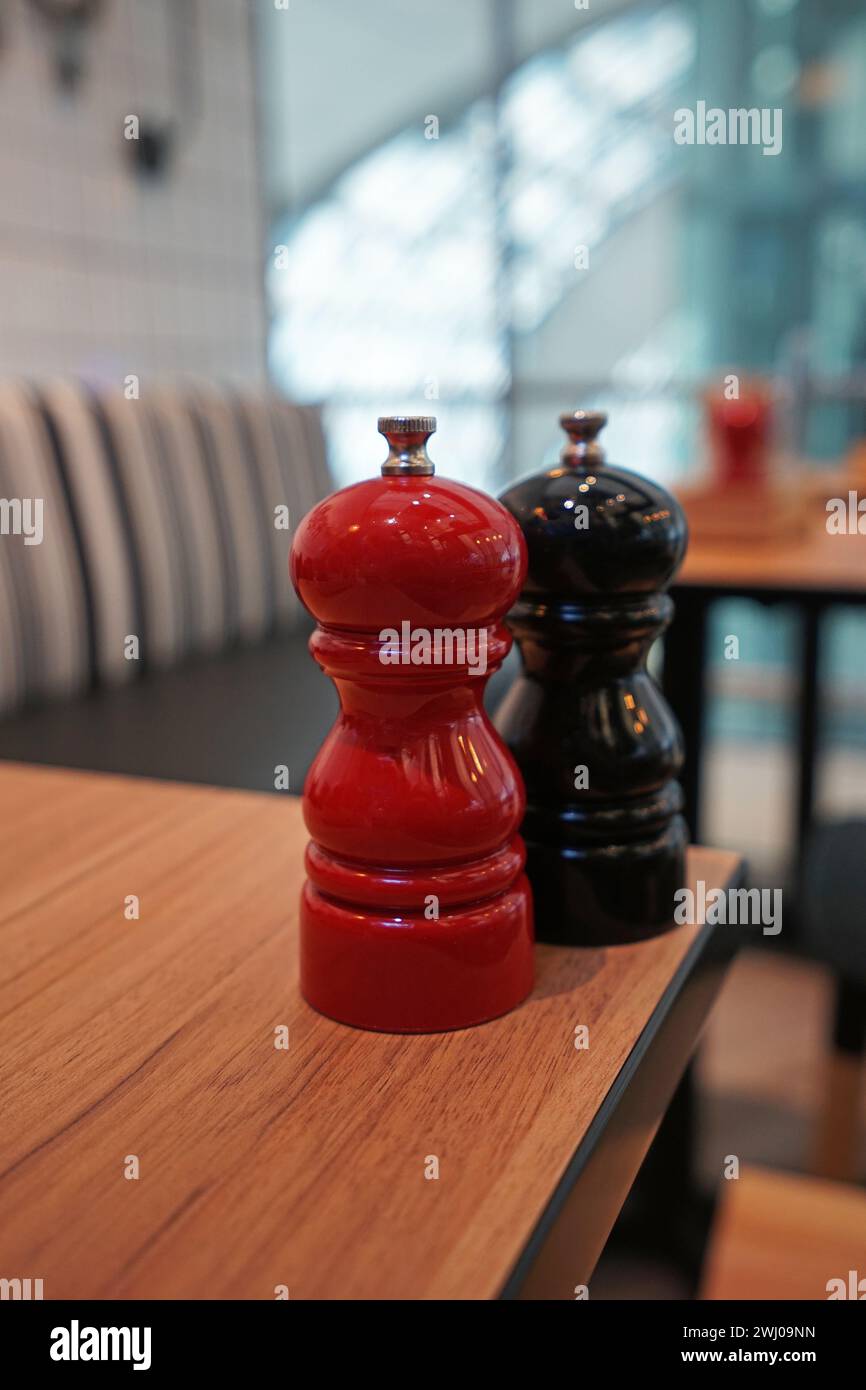 Close up Ceramic salt and pepper seasoning shaker on wooden table Stock Photo