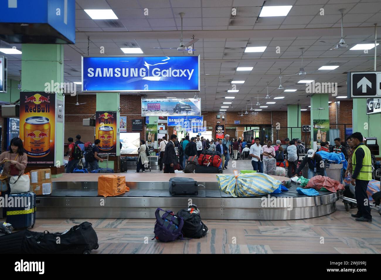 Interior architecture design and decoration of Baggage claim area and carousel at Tribhuvan international airport with crowded waiting passengers Stock Photo