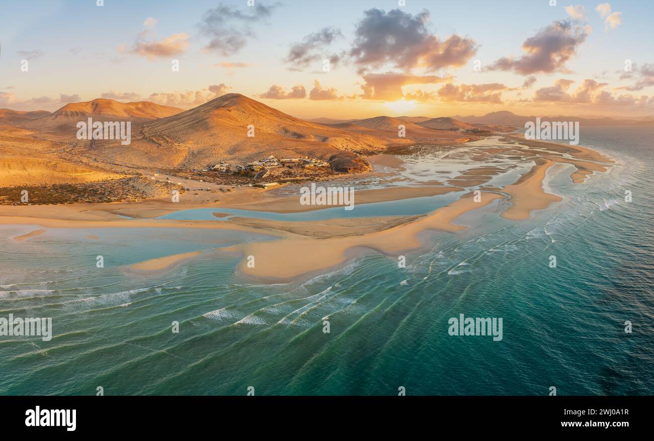 Playa de Sotavento at sunrise, Fuerteventura: a breathtaking aerial view of crystal-clear lagoons and sweeping sand dunes on this iconic Canary beach. Stock Photo