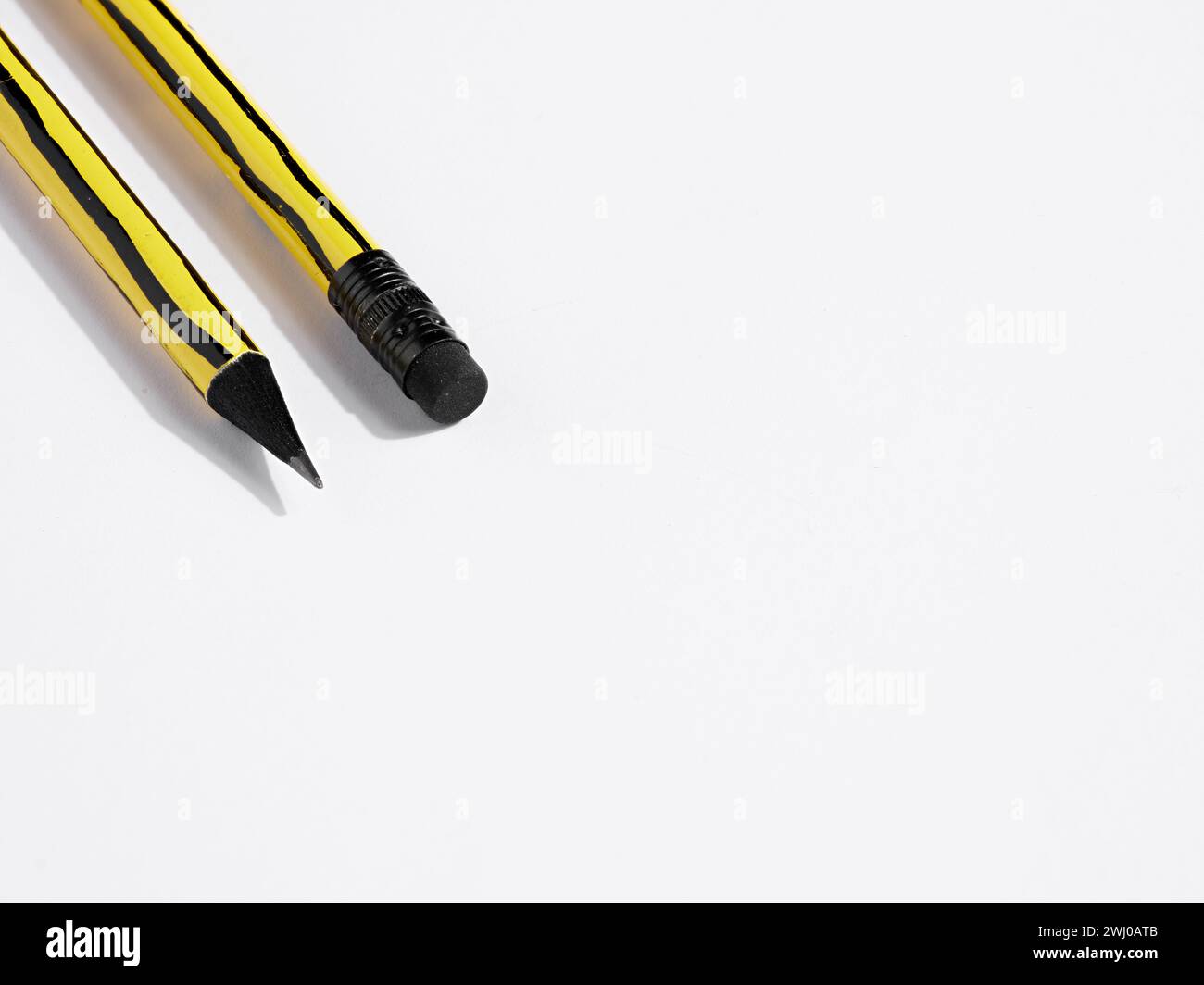 Close up view of a pencil tip and eraser on white background with copy space. Write and erase. Correct errors and mistakes. Editing. Stock Photo