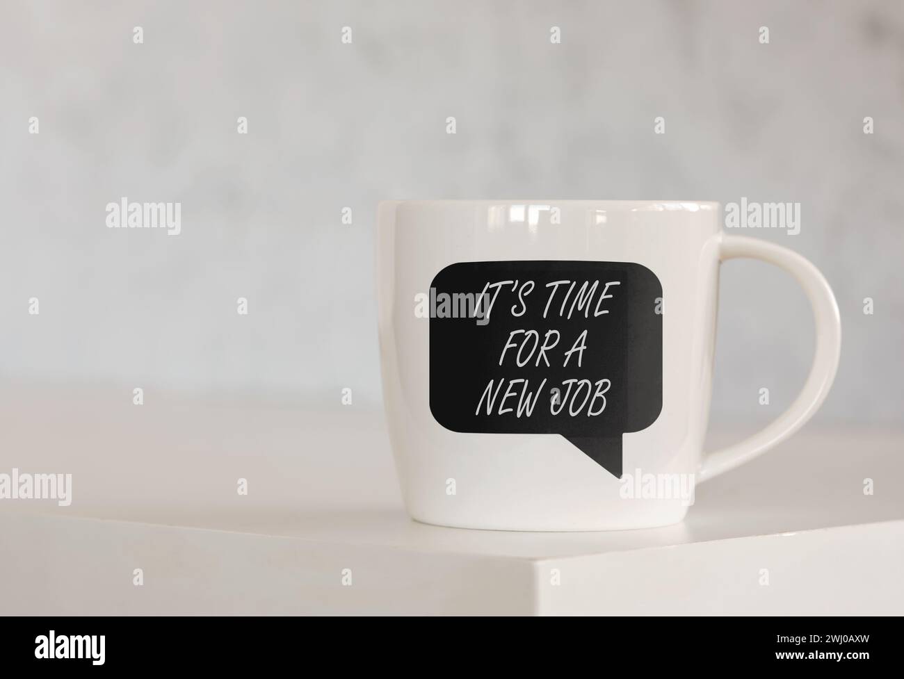The message it is time for a new job on a speech bubble printed on a coffee mug over the table. Business, recruitment and career change concept. Stock Photo