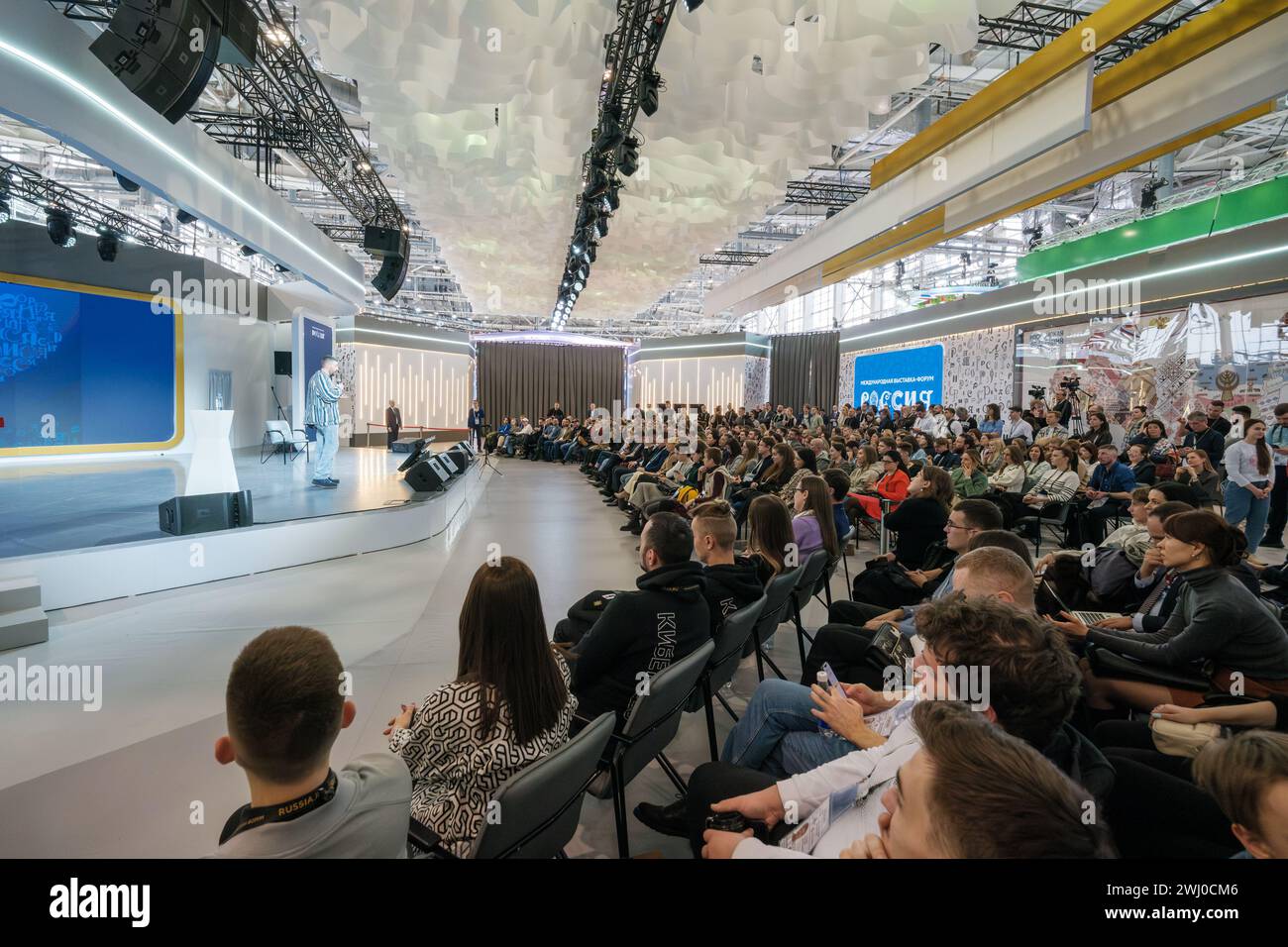 Moscow - February 6, 2024: Engaged audience listening to a speaker at a tech conference in a contemporary hall with dynamic lighting. Stock Photo