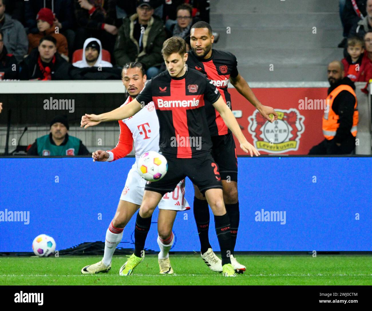 BayArena Leverkusen Germany,  10.2.2024, Football: Bundesliga Season 2023/2024 matchday 21.,  Bayer 04 Leverkusen (B04) vs FC Bayern Muenchen (FCB) — from left: Leroy Sane (FCB), Josip Stanisic (B04), Jonathan Tah (B04) Stock Photo