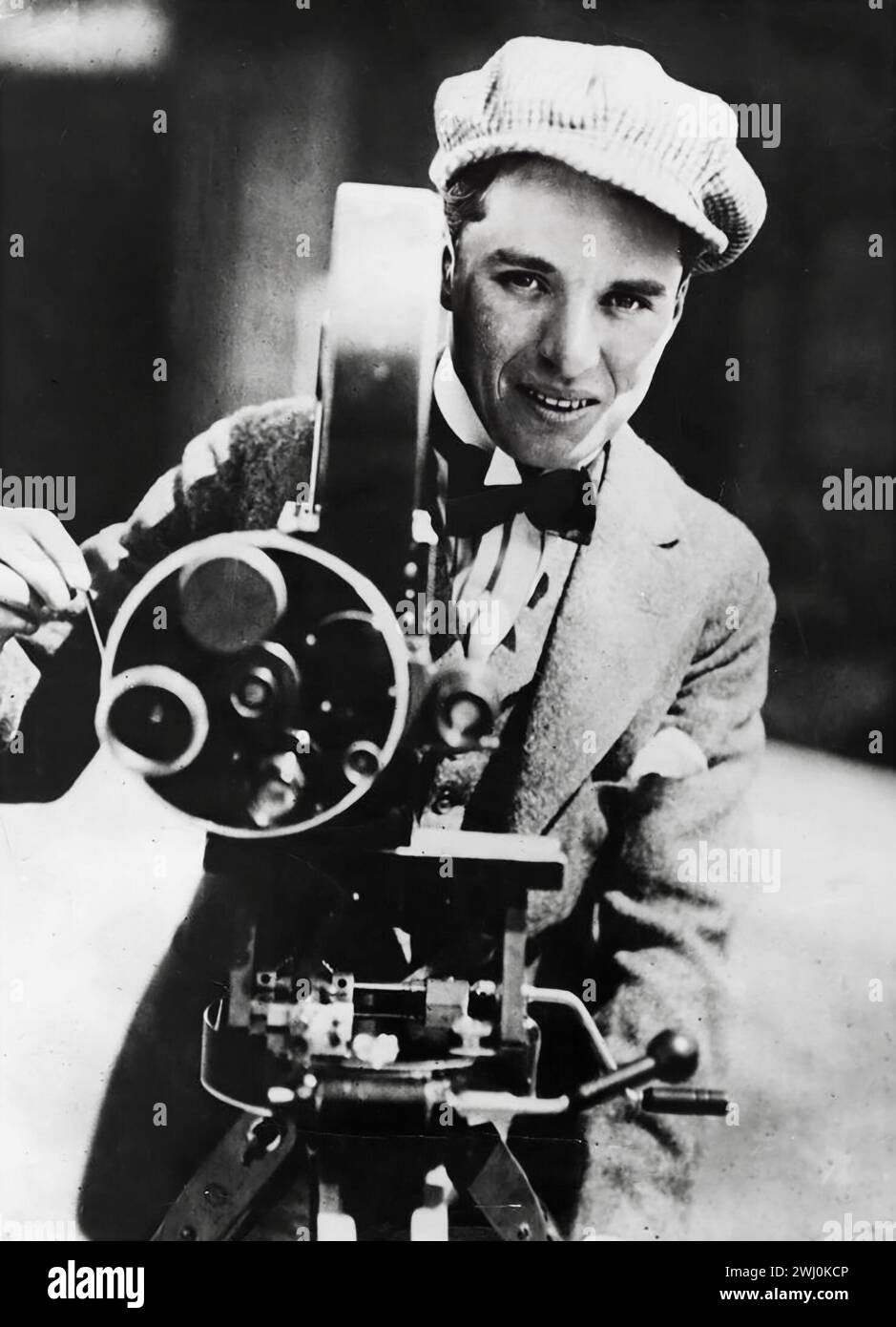 Legendary Charlie Chaplin (1889 - 1977) English film pioneer, actor and director, operating a movie camera, 1915 Stock Photo
