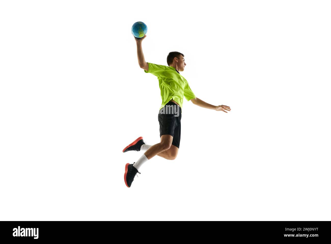 Dynamic image of young man in uniform, handball player in motion during game, practicing