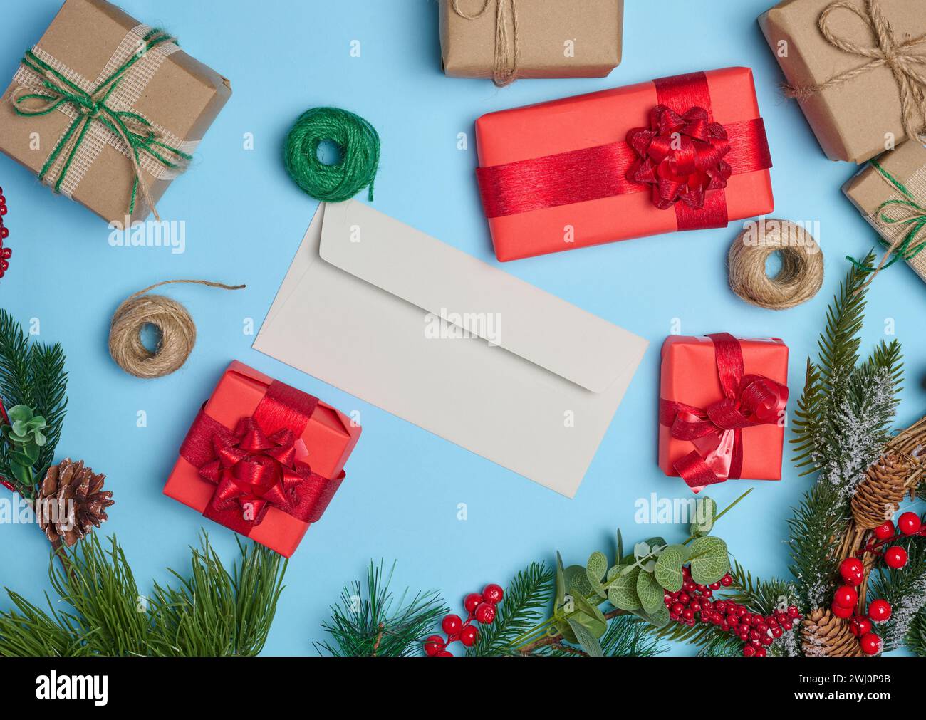 Christmas decor, gifts wrapped in red paper and a letter on a blue