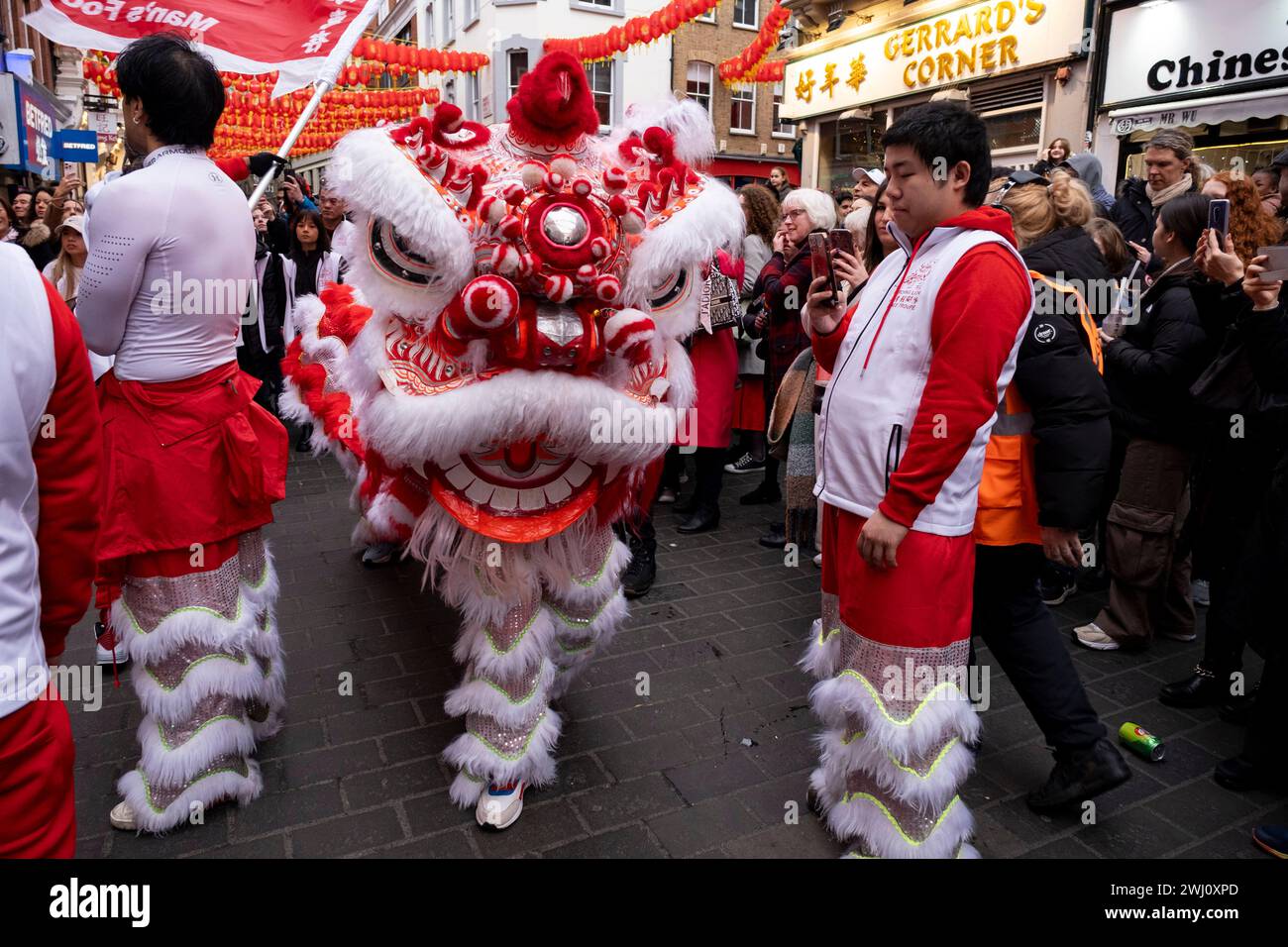 Lion Dance to celebrate the Chinese New Year of the Dragon which enters restaurants in Chinatown to bless them for the year ahead on 10th February 2024 in London, United Kingdom. Chinatown is an ethnic enclave bordering Soho and currently occupies the area in and around Gerrard Street. It contains a number of Chinese restaurants, bakeries, supermarkets, souvenir shops, and other Chinese-run businesses. Stock Photo