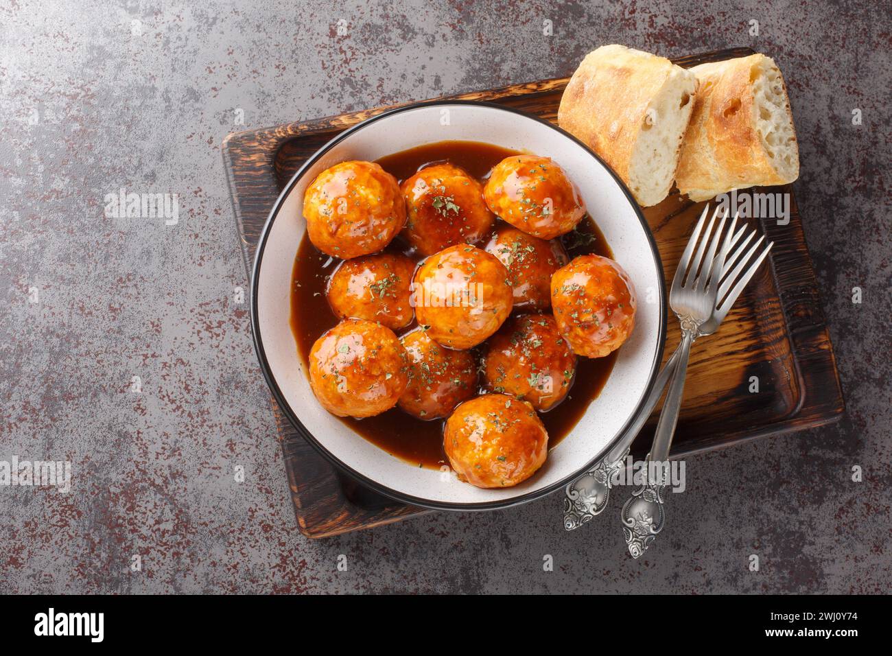 Chicken Meatballs with Chipotle Honey Sauce closeup on the bowl on the table. Horizontal top view from above Stock Photo