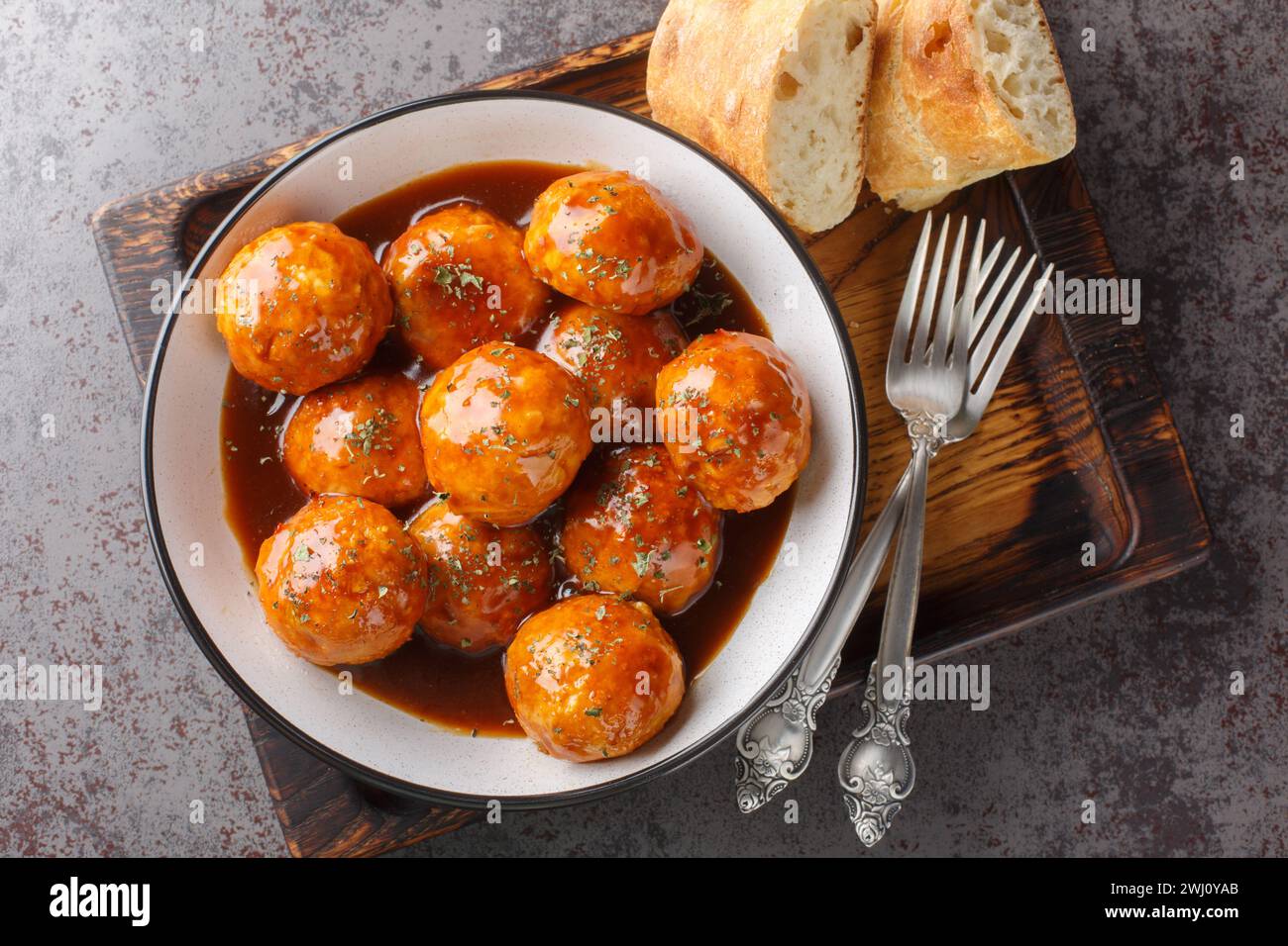 Spicy and sweet, chipotle honey glazed meatballs closeup on the bowl on the table. Horizontal top view from above Stock Photo