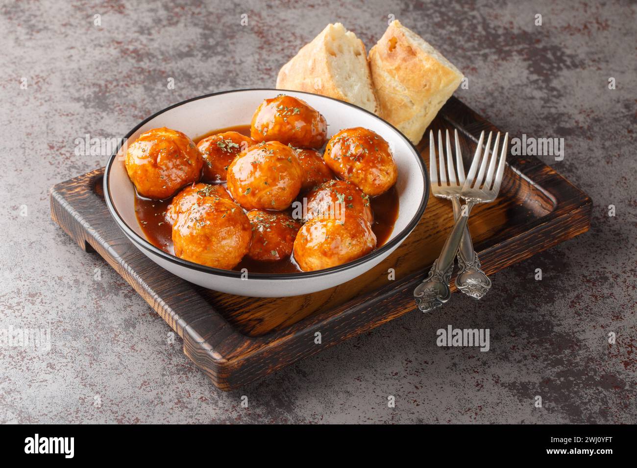 Spicy and sweet, chipotle honey glazed meatballs closeup on the bowl on the table. Horizontal Stock Photo
