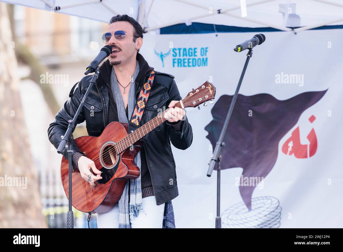 Whitehall, London, UK. 11th February 2024. Sepp Osley performs at a Stage of Freedom event where British Iranian diaspora and supporters protest the regime on the 45th anniversary of the 1979 Revolution. The majority of Iranians consider the  Islamic Revolutionary Guard Corps (IRGC), who have a role in nearly every aspect of Iranian politics and society, as an obstacle to the life they want to live.  Photo by Amanda Rose/Alamy Live News Stock Photo