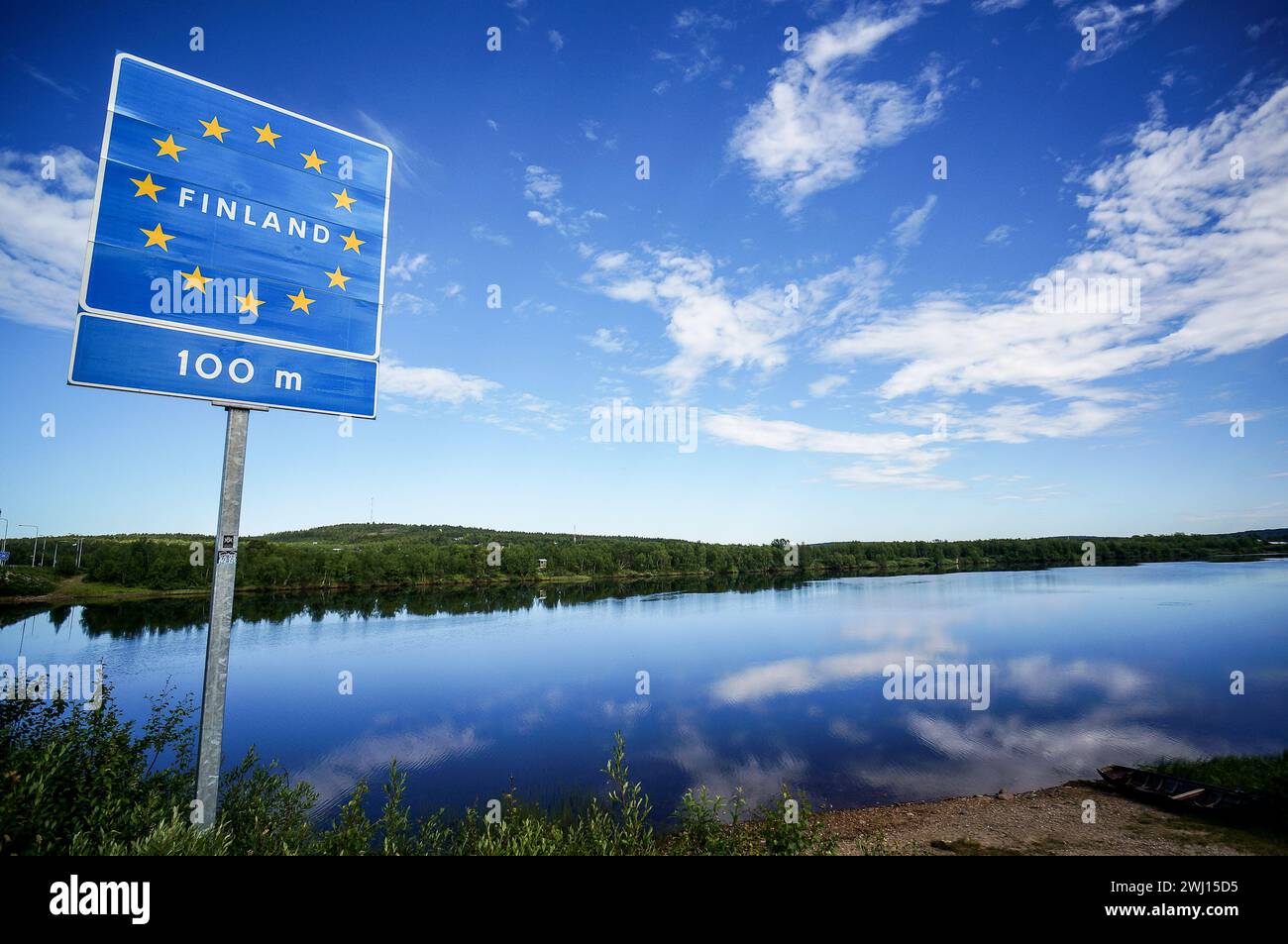 Finland Border Road sign, finland and sweden border on a lake Stock Photo