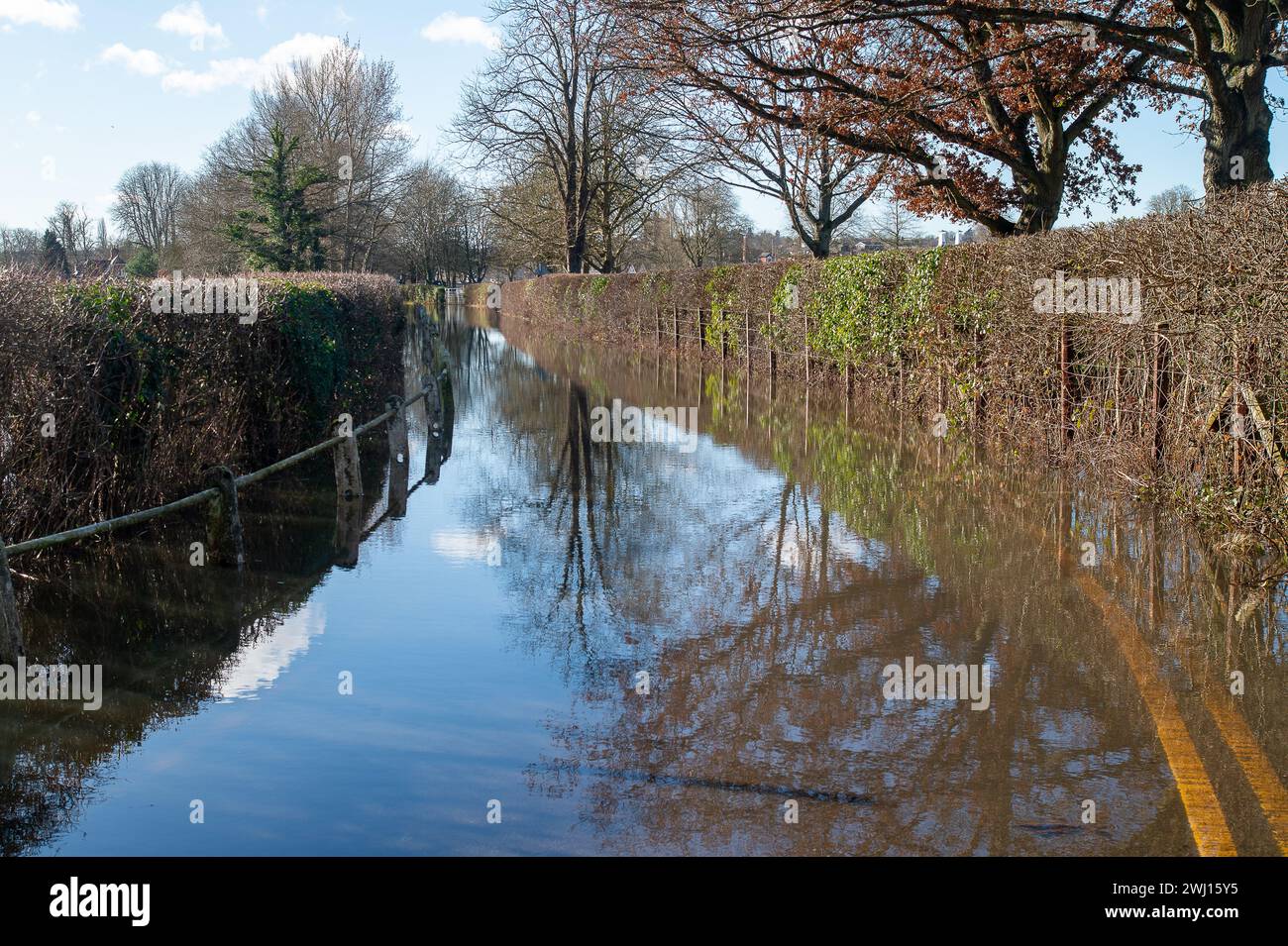 The road between Remenham and Henley is closed due to flooding. The River Thames has burst its banks at Henley on Thames in Oxfordshire. A Flood Warning is in place for the River Thames for Henley, Remenham and Medmenham. Property flooding is expected and river levels are expected to continue to rise Stock Photo