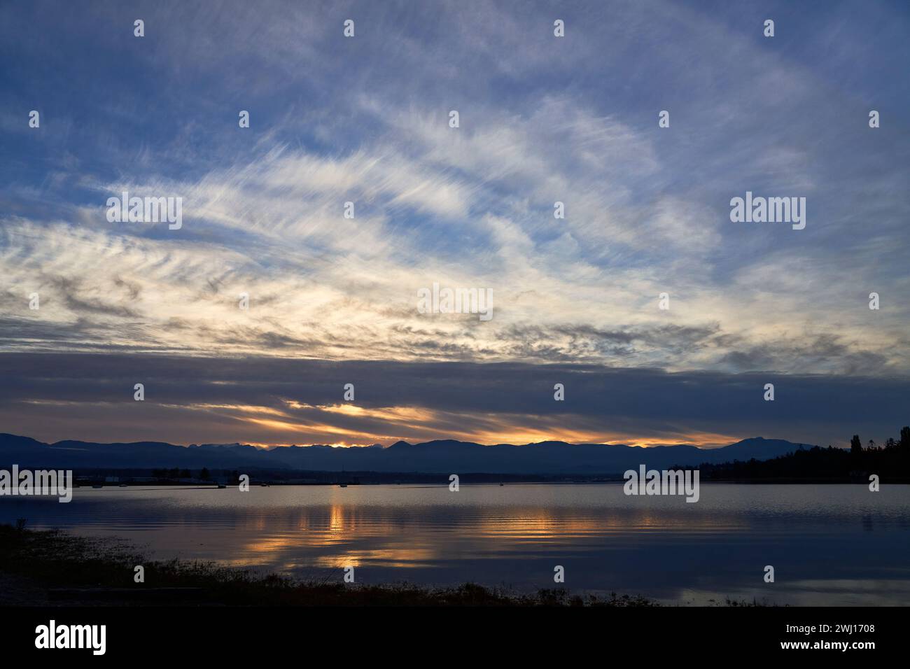 Sunset on the ocean, Dramatic blue and orange sky. Stock Photo