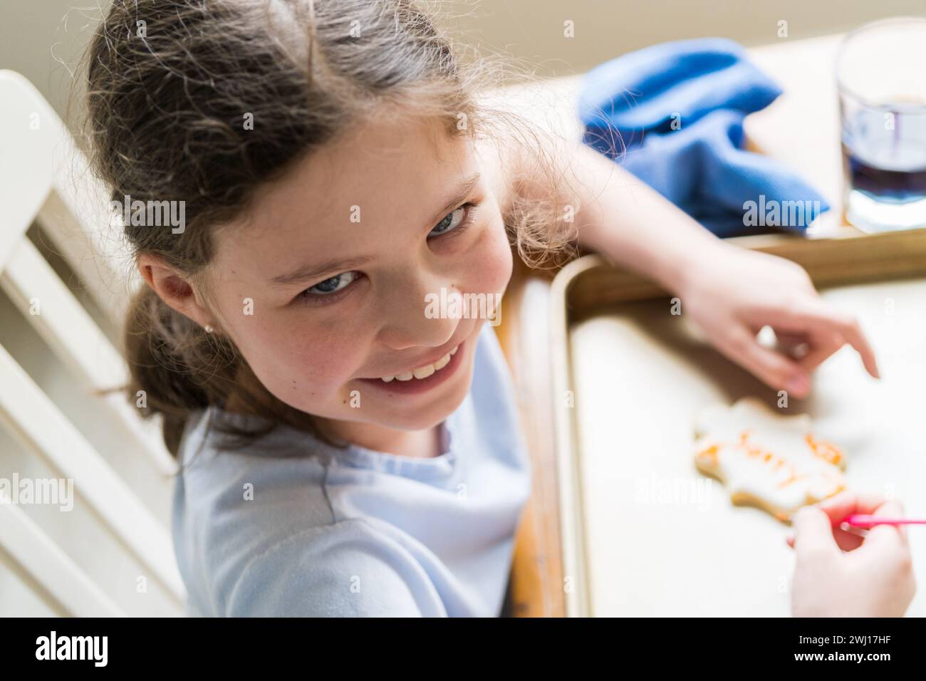 Little Girl Spells 'Sorry' on Iced Sugar Cookies Stock Photo