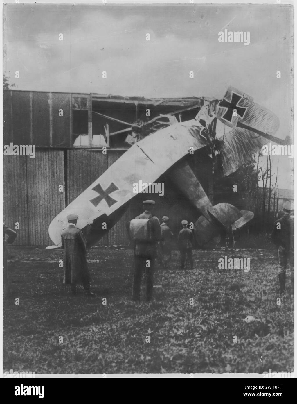 Germans gazing at one of the crashed plane, into a barn France circa 1917 Stock Photo