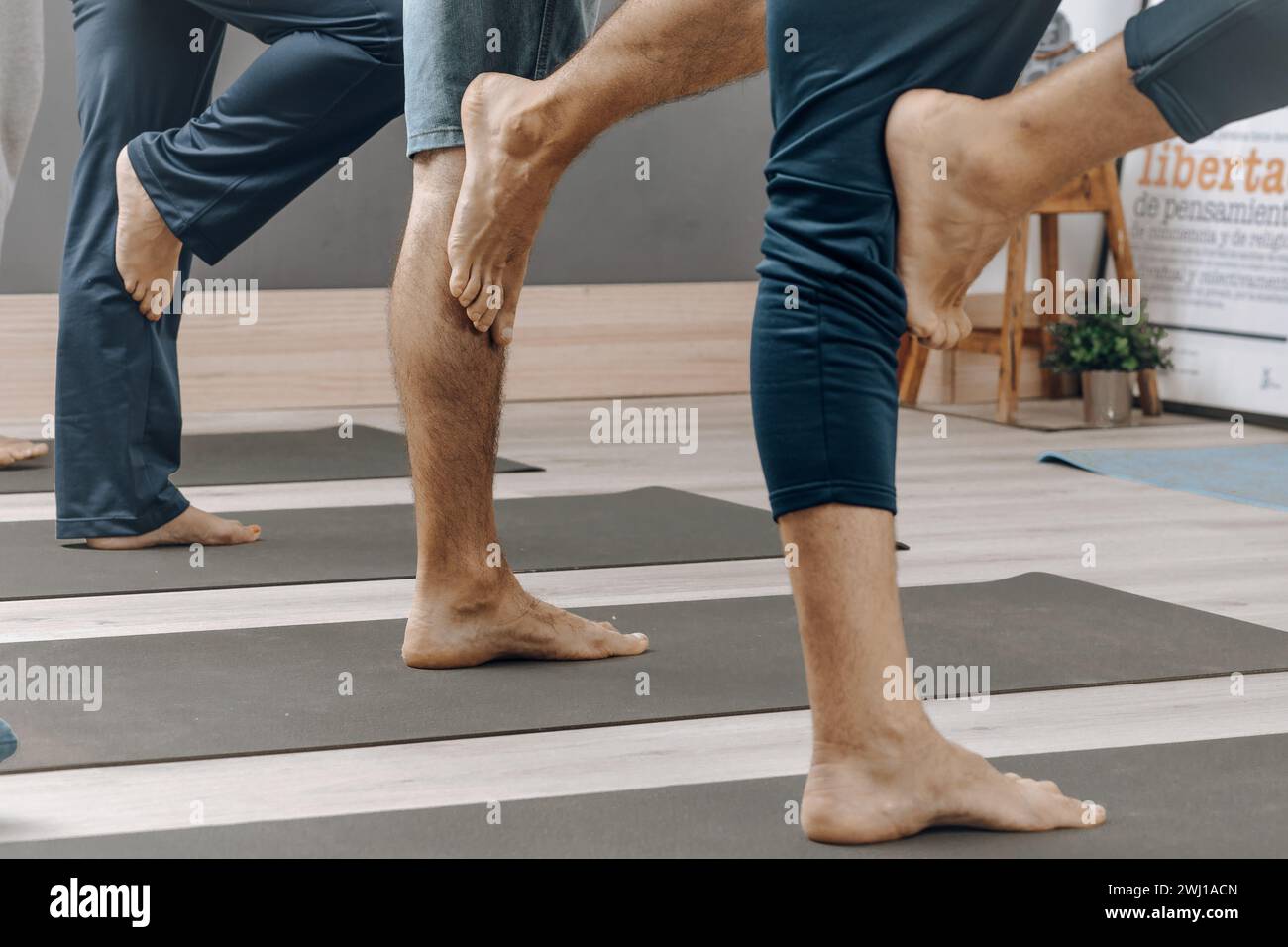 Group doing calf muscle stretches on yoga mats Stock Photo