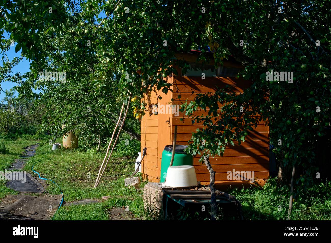 Small building in the garden in the village, in summer Stock Photo