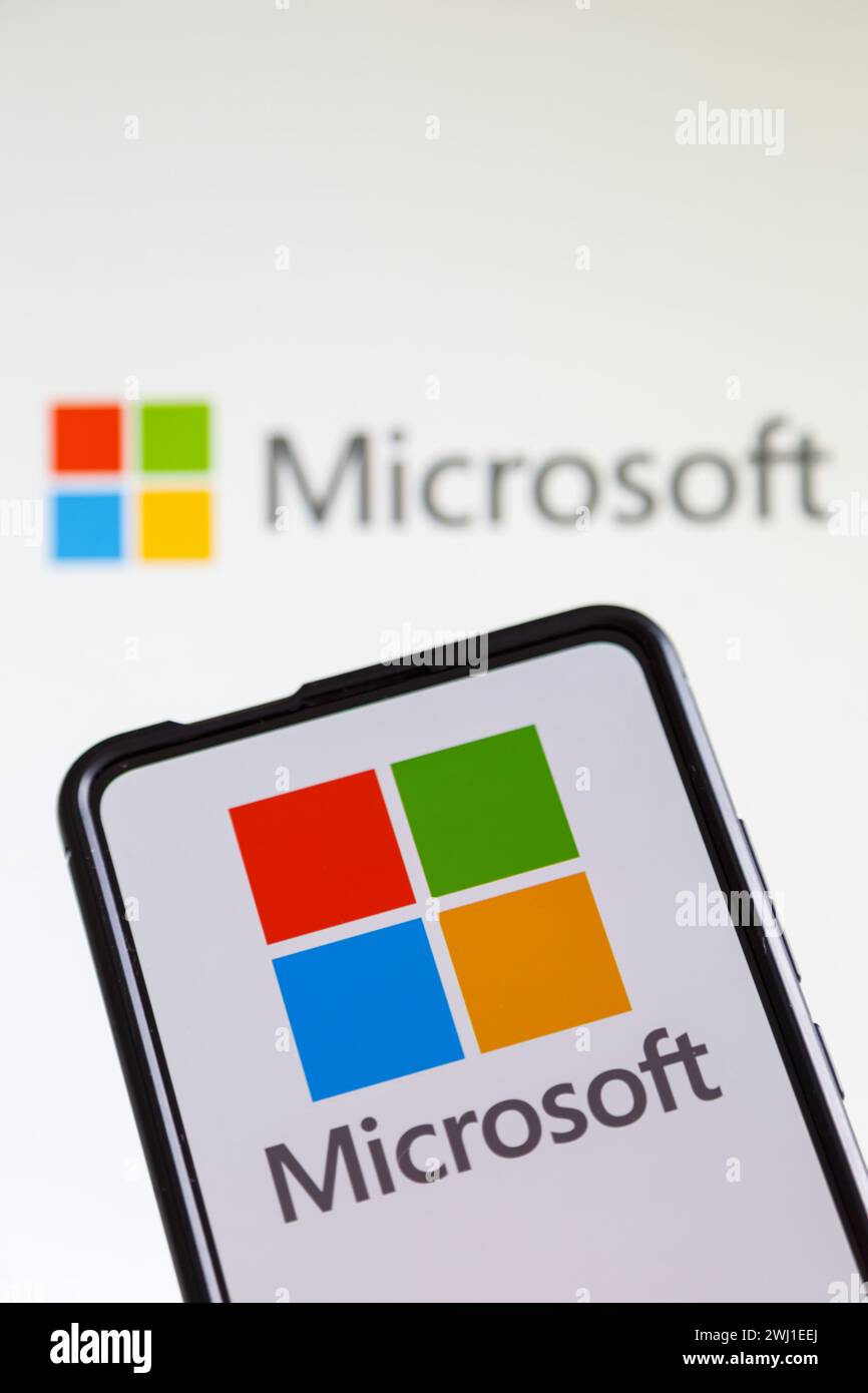 Microsoft logo of the software company on a cell phone and computer screen Stock Photo