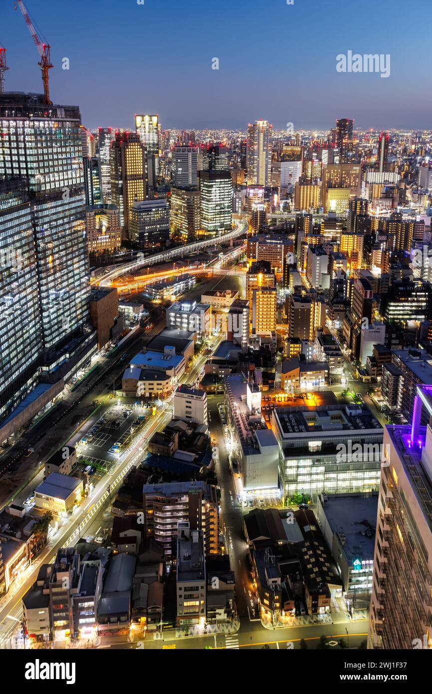 Osaka city from above with the skyline skyscrapers portrait format at night in Japan Stock Photo