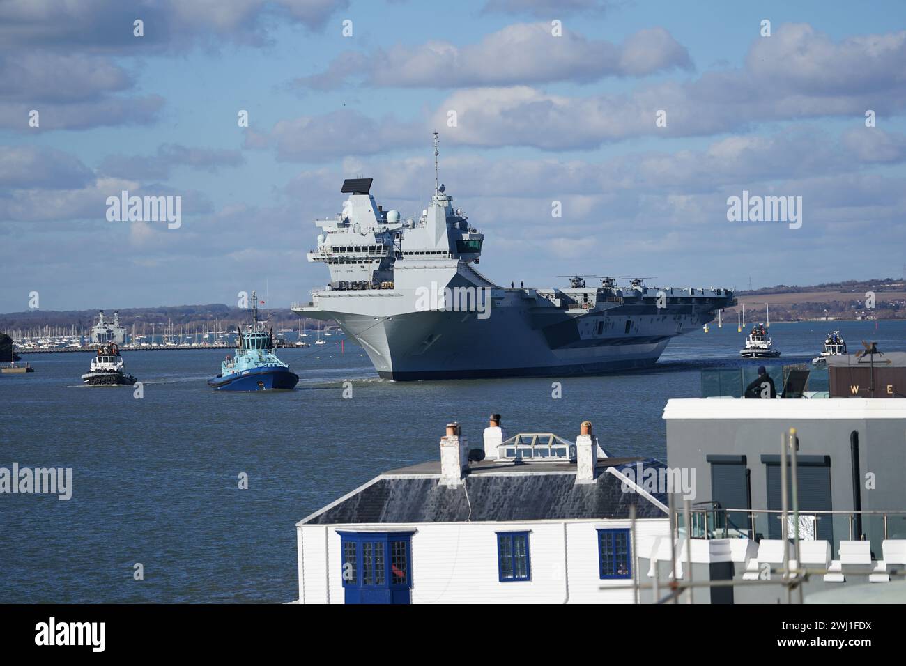 Royal Navy aircraft carrier HMS Prince of Wales sets sail from Portsmouth Harbour to lead the largest Nato exercise since the Cold War, involving more than 40 vessels, after its sister ship was forced to cancel its deployment because of an 'issue' with its propeller shaft. Picture date: Monday February 12, 2024. Stock Photo