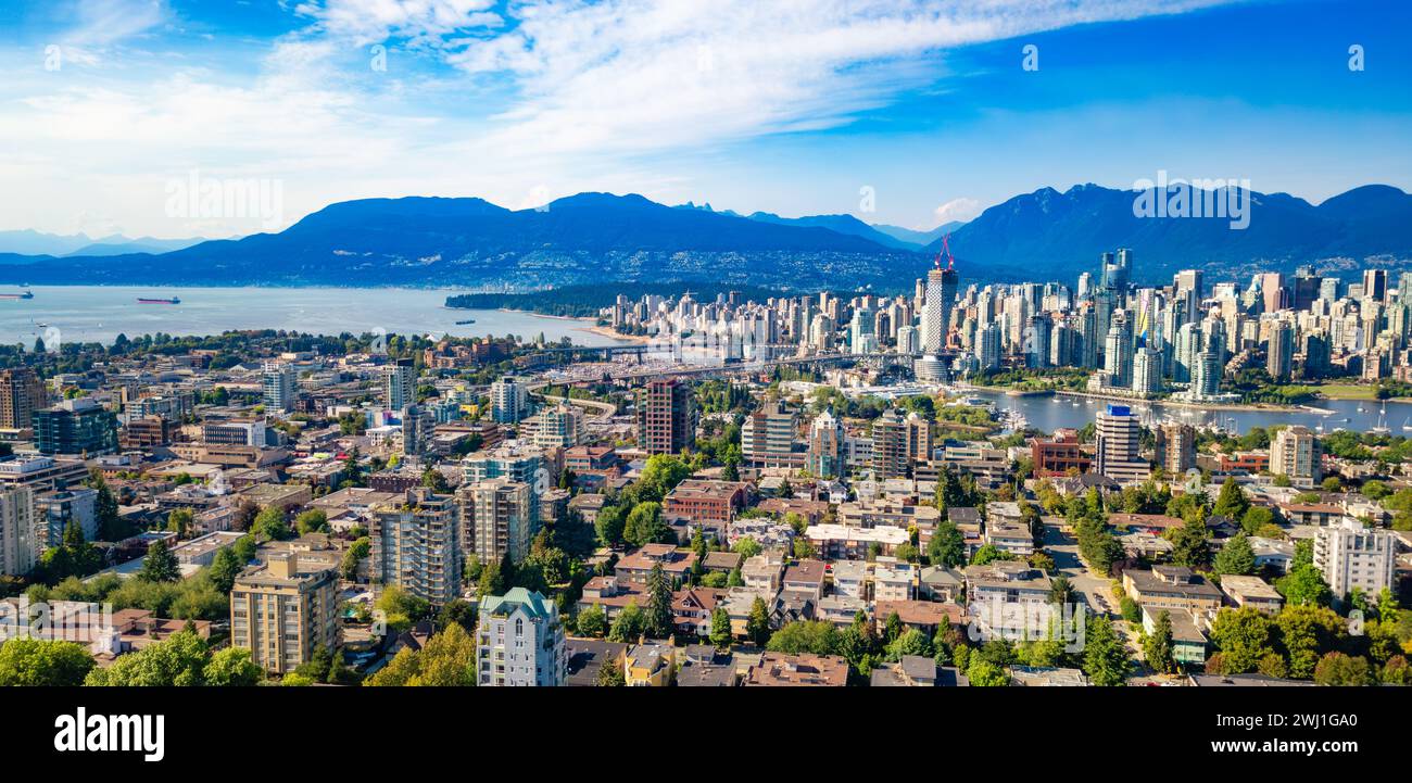 An aerial view of Vancouver with majestic mountains in the background ...
