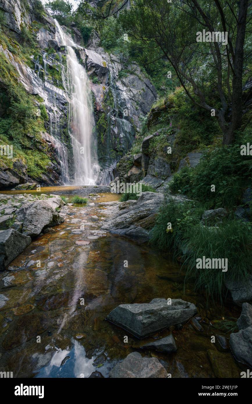 Waterfall caresses the granite rock before falling into a pool and forming a stream in Toxa Pontevedra Galicia Stock Photo