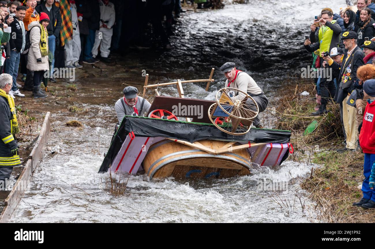Schramberg, Germany. 12th Feb, 2024. Jörg Fehrenbacher and Georg Haas ride along the Schiltach under the motto "Mit unsrer Draisine ghots da Bach nuff" during the Da-Bach-na-Fahrt. The participants ride their "Zuberboote" on the 400 meter long route. The aim is to arrive at the finish line with dry feet. Credit: Silas Stein/dpa/17�Թ����� Live News Stock Photo