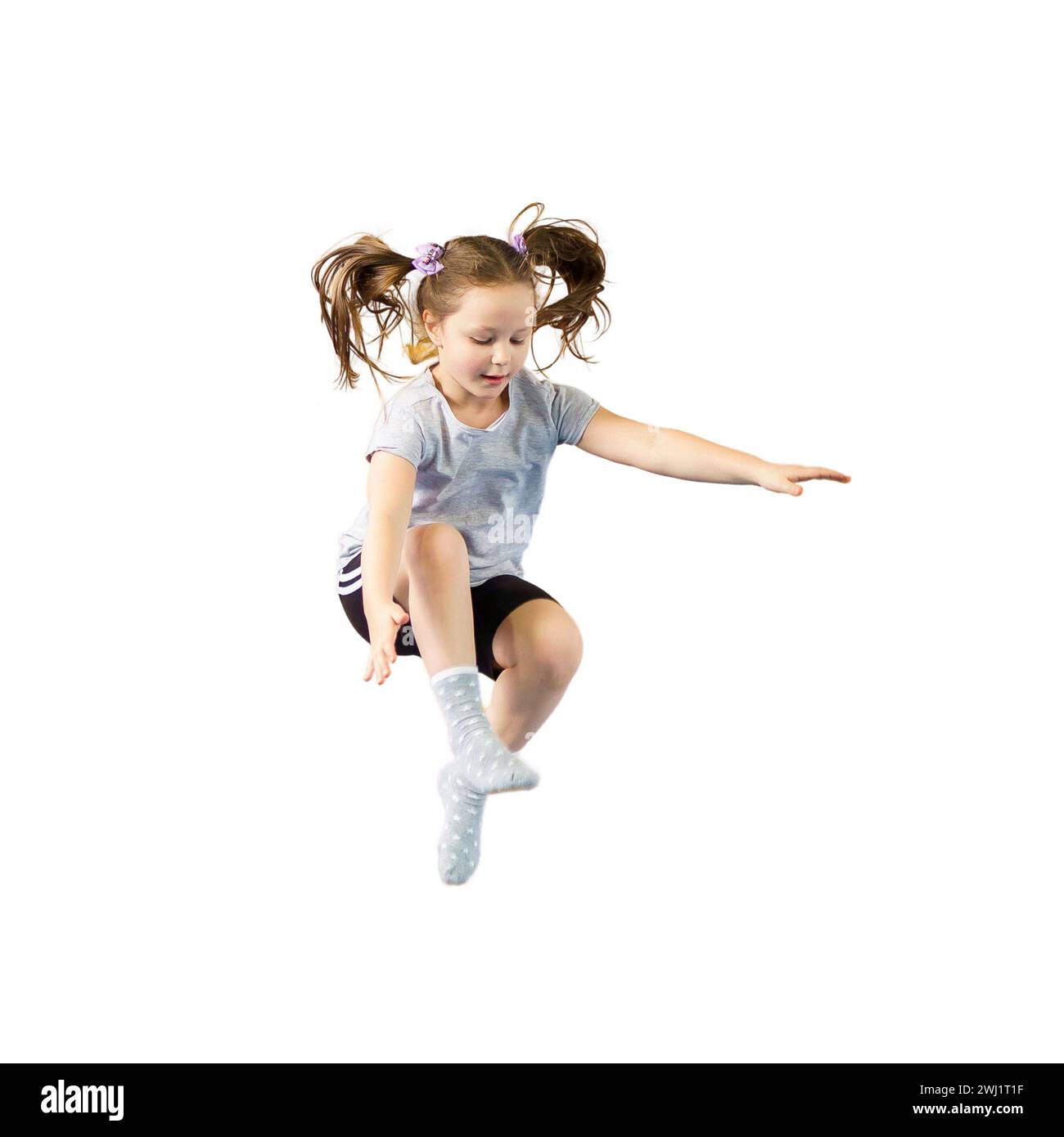 Happy little girl jumping isolated on white background Stock Photo - Alamy