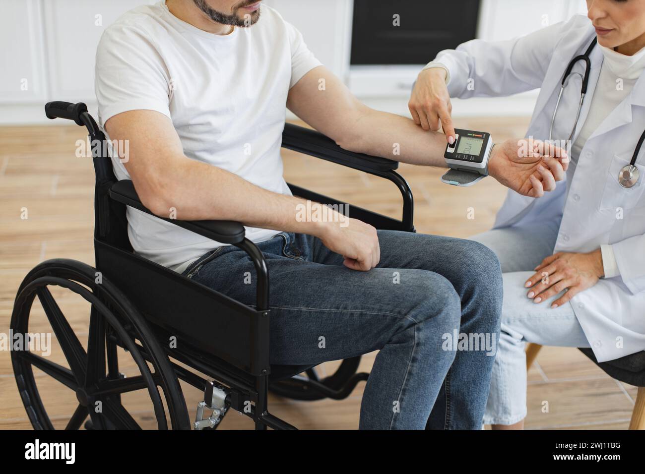 Crop of female doctor and patient with disability having talk about ...
