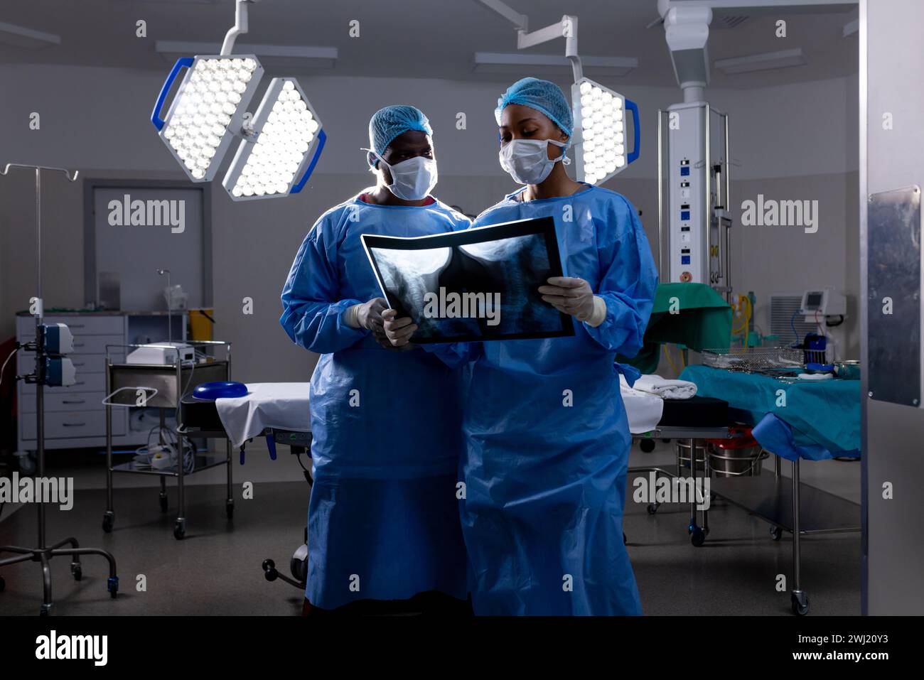 African American Male And Female Doctors With Face Masks Looking At X 