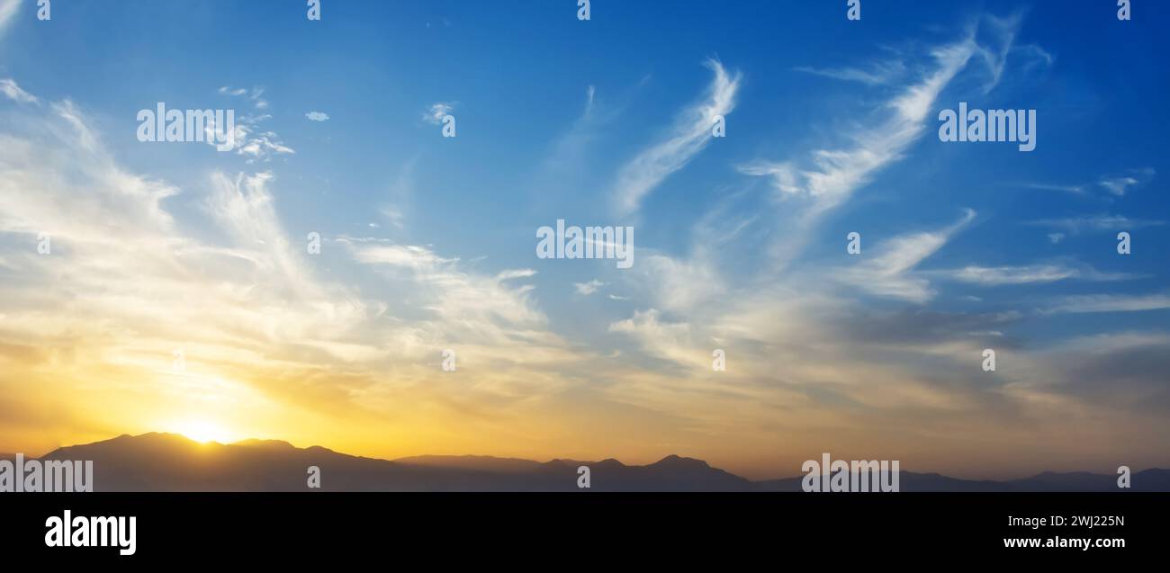 Panoramic view sky sunset cirrus clouds mountains Stock Photo