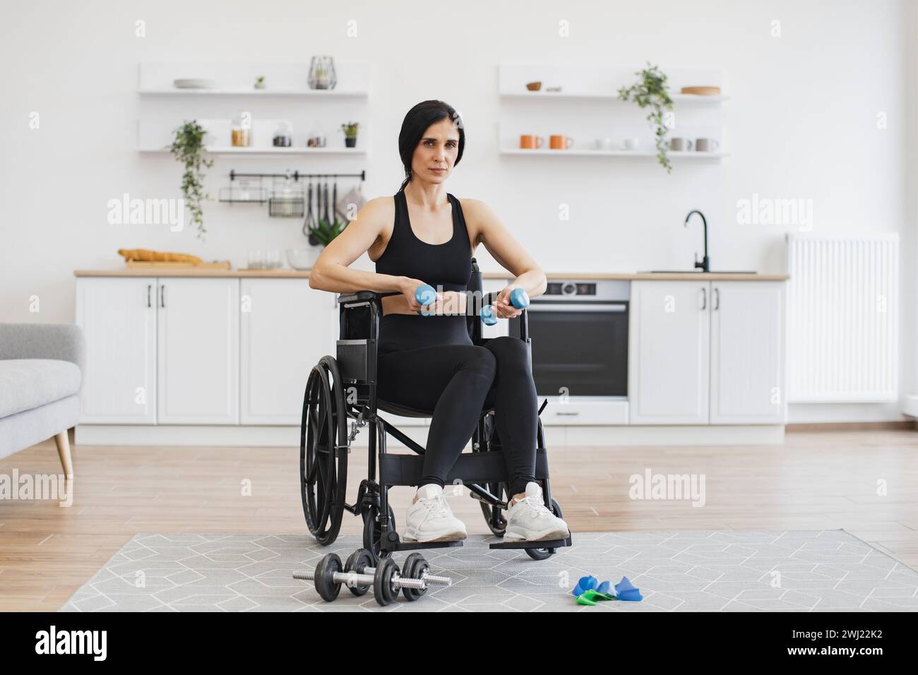 Caucasian female with mobility impairment doing seated exercises with