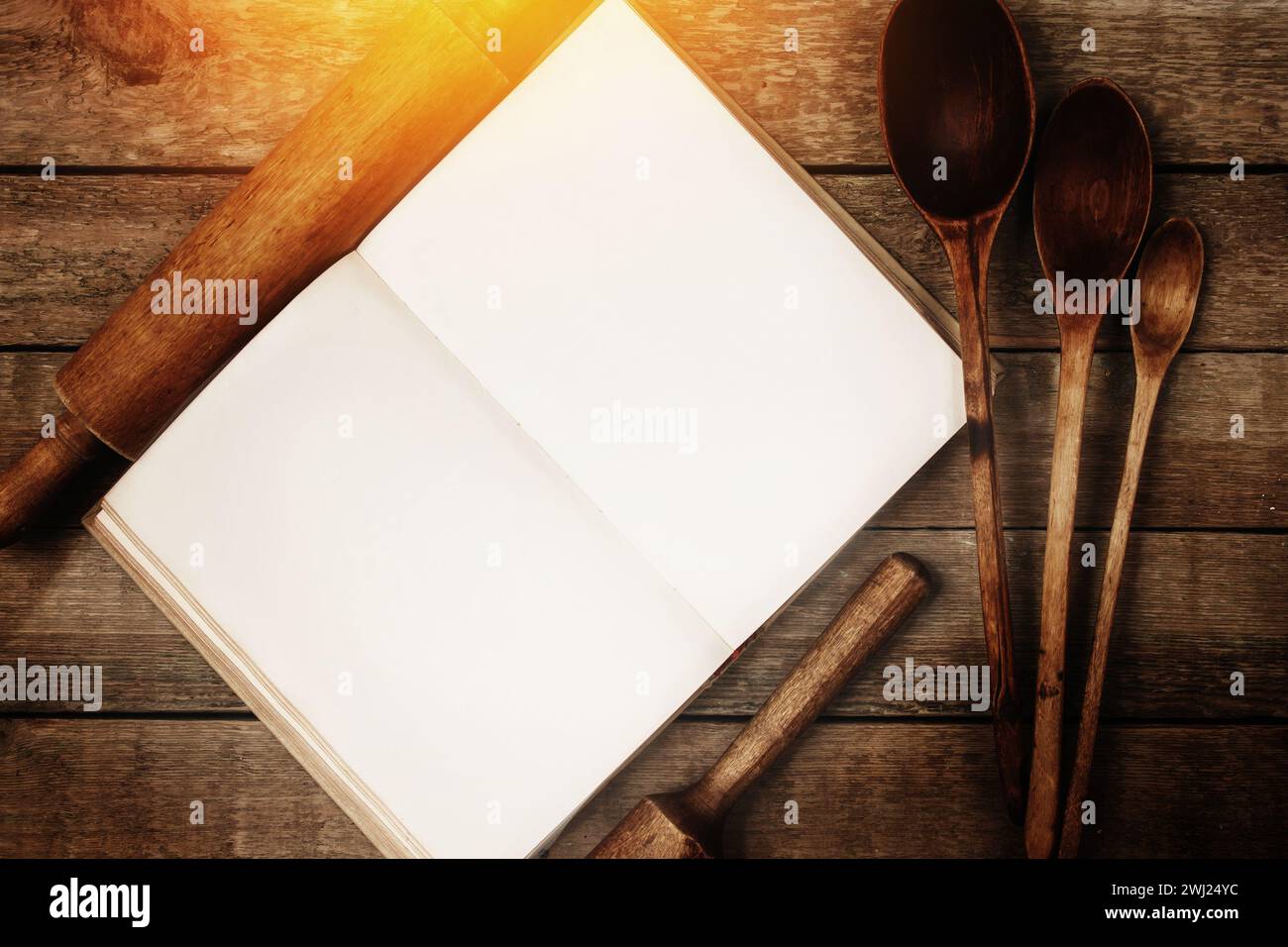 Various wooden kitchen utensils and vintage cookbook on the table Stock ...