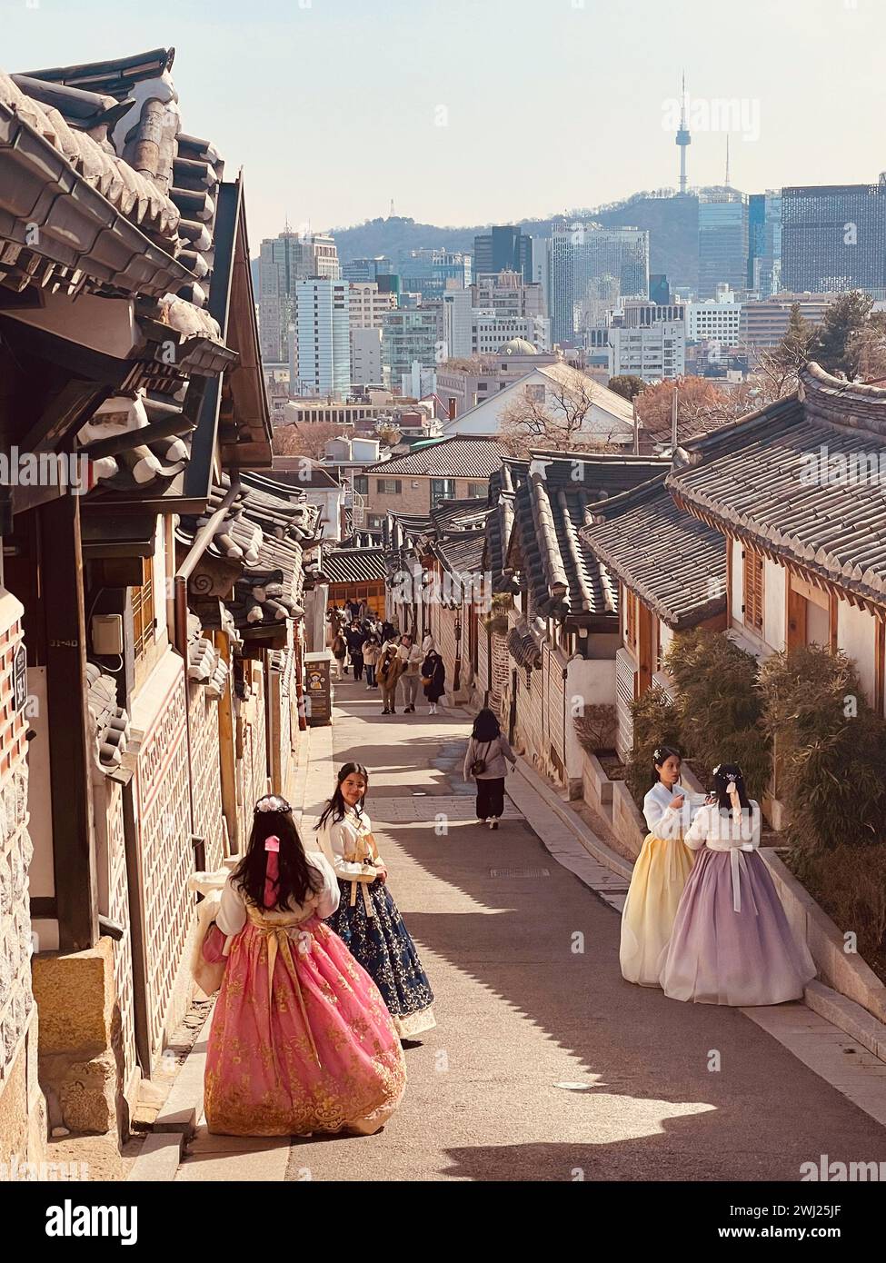 SEOUL - Girls in traditional hanbok dresses ppose in the streets of Bukchon Hanok Village Stock Photo