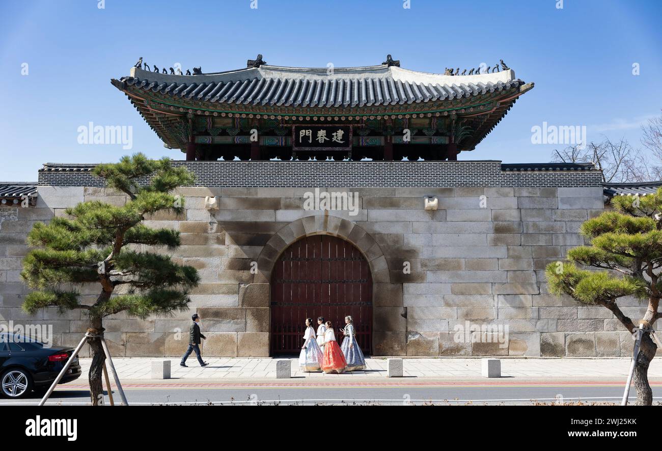 SEOUL - Girls in traditional Korean hanbok dresses walk past the Gyeongbokgung Palace in the city of Seoul, South Korea Stock Photo